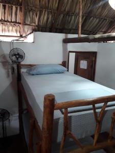 a bedroom with a bed in a room at Backpackers Hostel in Sipacate