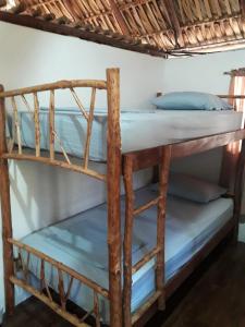 a couple of bunk beds in a room at Backpackers Hostel in Sipacate