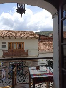 a balcony with a table and a view of a building at Cusco Plaza de Armas in Cusco