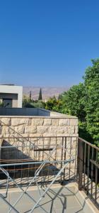 a railing on top of a stone wall at Studio at the Kibbutz in Ashdot Ya‘aqov
