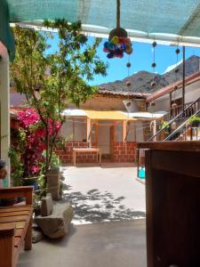 a view of a building with a patio with trees at Hostal Raymi in Ollantaytambo