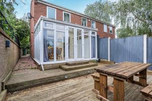 a patio with a bench and a house at Emma's Central House & Parking in Nottingham