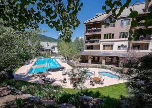 a large swimming pool in front of a building at Beaver Creek Highlands Lodge 209 in Beaver Creek