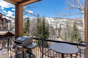 a grill on a balcony with a mountain view at Beaver Creek Highlands Lodge 209 in Beaver Creek