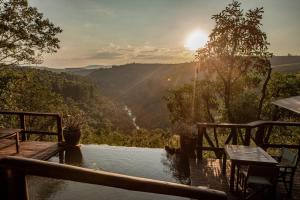 a wooden deck with a view of the mountains at Tanamera Lodge in Hazyview