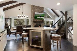 a kitchen and dining room with a large island with bar stools at West Vail Matterhorn Circle 5 in Vail