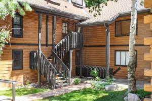 a home with a wooden house with a black railing at West Vail Interlochen Condo B8 in Vail