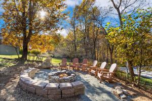 a group of chairs sitting around a fire pit at Alpine Retreat in Seven Devils