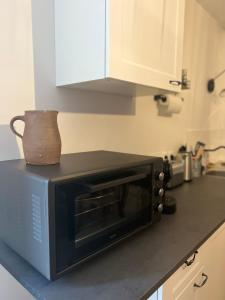 a microwave oven sitting on a counter in a kitchen at L’Etape, cœur de ville in La Charité-sur-Loire