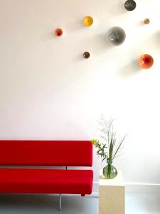 a living room with a red couch and lights at LE GARAGE Downtown serviced apartment in The Hague