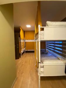 a room with three bunk beds and a hallway at Rodin Hostel in Istanbul
