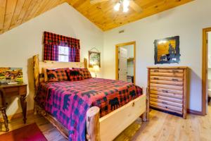 a bedroom with a bed and a dresser at Smoky Mountain Cabin with Fire Pit Hike and Fish! in Murphy