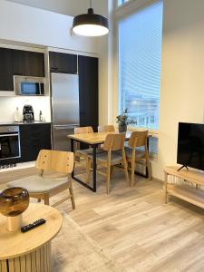 a kitchen and dining room with a table and chairs at Näsijärvi lakeview apartment in Tampere