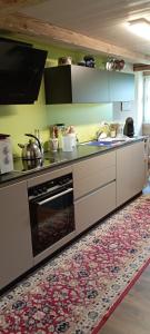 a kitchen with a stove and an oven at DesAlpes in Saxeten +7 photos