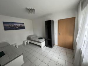 a living room with a couch and a bed at Schöne Apartments am Wasserturm Mönchengladbach MG33 und MG34 in Mönchengladbach