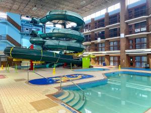 a water slide in a building with a swimming pool at Medicine Hat Lodge, Trademark Collection by Wyndham in Medicine Hat