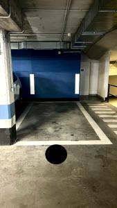 an empty parking garage with a blue wall at Naia´s Living T3 in Bilbao