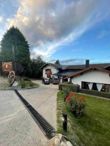 a house with a driveway and a building at El Molino in San Carlos de Bariloche