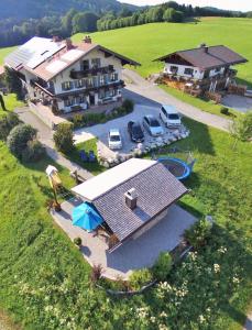 an aerial view of a large house with a parking lot at Matheishof in Ruhpolding