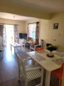 a kitchen and living room with a table and chairs at Kensington Oval- 2 bed 1 Bath in Bridgetown