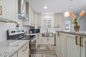 a kitchen with white cabinets and a sink at Helena's Place, Exclusive End Unit Townhouse in Destin