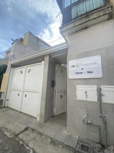 a building with two garage doors and a sign on it at Villa la rosaverde 