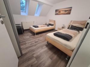 a room with two beds and a couch at Wohnung mit 2 Schlafzimmern in Wutöschingen