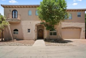 a large house with a driveway and a garage at Luxury Tuscan Villa Near Old Town in Albuquerque