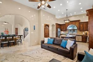 a living room with a couch and a kitchen at Luxury Tuscan Villa Near Old Town in Albuquerque