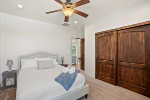 a bedroom with a bed with a ceiling fan at Luxury Tuscan Villa Near Old Town in Albuquerque