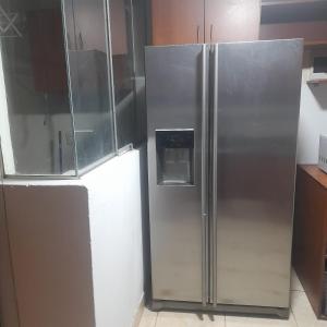 a stainless steel refrigerator in a kitchen at Departamento zona exclusiva Cayma Arequipa in Cayma