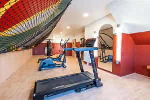 a gym with two treadmills and a gym at Résidence Kley Angers Centre in Angers