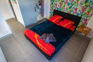 um quarto com uma cama com uma flor em Sibèl Appart em Fort-de-France