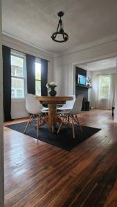 a dining room with a table and chairs on a wooden floor at This Old House in Detroit