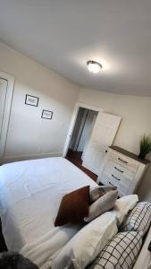 a bedroom with a large white bed and a couch at This Old House in Detroit +27 photos