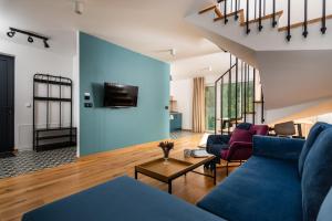 a living room with a blue wall at Klimczok Apartamenty in Bystra