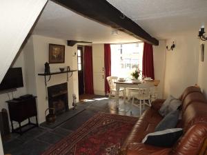 a living room with a couch and a table at 18th Century character cottage, Broughton-in-Furness in Broughton in Furness