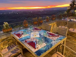 a table on a balcony with a view of the city at Hotel Berti in Assisi