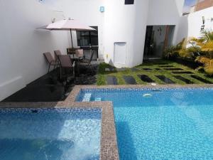 a swimming pool in the backyard of a house at Killamoon House Paracas in Paracas