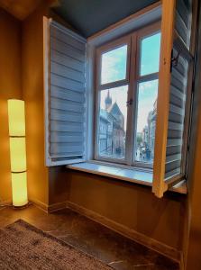 a window in a room with a view of a city at Studio Flat With a View in Krakow