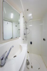 a bathroom with a sink and a mirror and a shower at All Inclusive Luxury Yacht with Private Island in Cancún