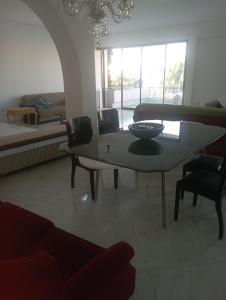 a living room with a table and a bed at manoussos home in Athens