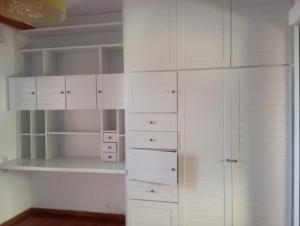 a white closet with white cabinets and shelves at manoussos home in Athens