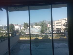 a view of a city from the window of a building at manoussos home in Athens