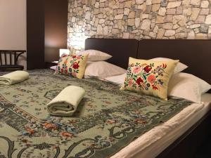 a bedroom with a bed with pillows on it at Mátrai pincés udvar in Mátramindszent +134 photos