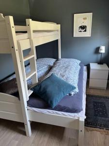 a white bunk bed with a blue pillow in a room at Henningsvær, Lofoten with fantastic view in Henningsvær