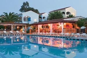 a hotel with a pool in front of a building at Cento Blu Villa in Gouvia