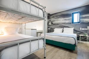 two bunk beds in a room with a mural at Lizbon South Bed in Barreiro