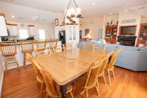 a dining room and living room with a table and chairs at Oceanside, Private Pool, Community Amenities, Hot Tub, VOH94, Knot A Problem in Corolla