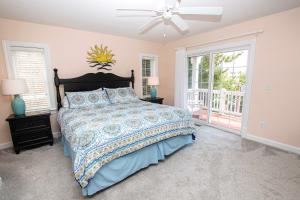 a bedroom with a bed and a ceiling fan at Oceanside, Private Pool, Community Amenities, Hot Tub, VOH94, Knot A Problem in Corolla +51 photos